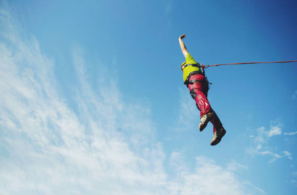 istock A man jumps into a canyon from a cliff. 902425724