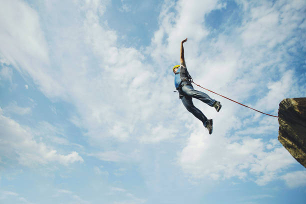 istock A man jumps into a canyon from a cliff. 902425814