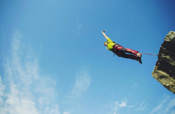 istock A man jumps into a canyon from a cliff. 902425840