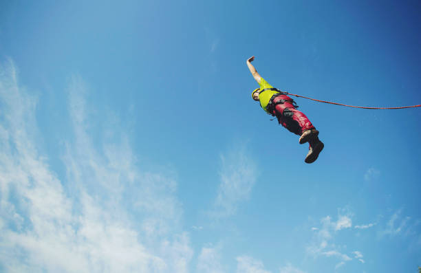 istock A man jumps into a canyon from a cliff. 902425848
