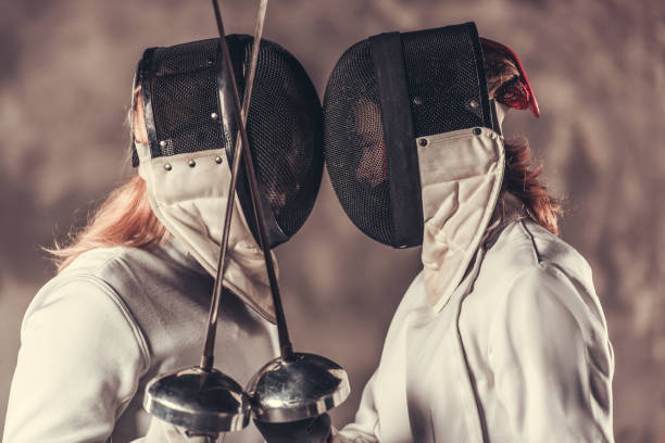 istock Two women fencing 902426104