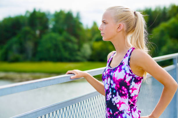 istock Thoughtful young woman rests after training 902426118