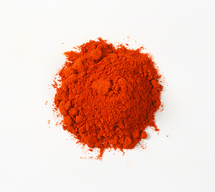Heap of ground red pepper on white background