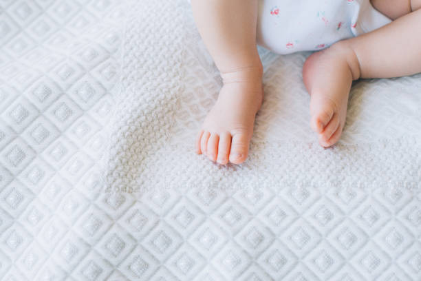 istock little newborn baby feet on white background 902428640