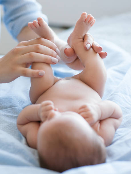 istock woman stretching feet infant baby 902428726