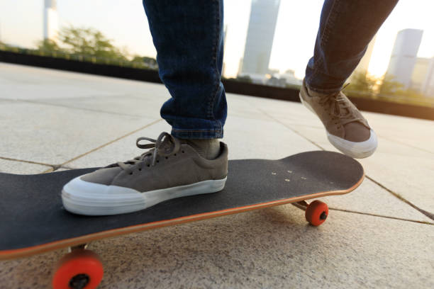 istock skateboarder legs riding with skateboard at city 902429446
