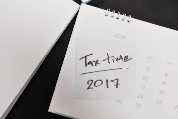istock Tax time on white paper. 902433454