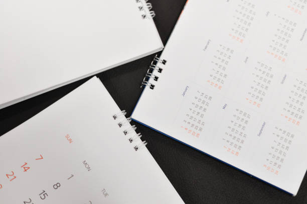 istock Close up white calendar on black background. 902434120