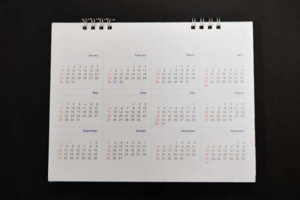 istock Close up white calendar on black background. 902434128