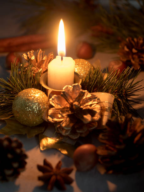 istock Christmas candles and ornaments over dark background with lights 902437060