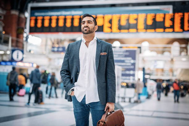 istock Indian commuter with briefcase standing on railway station 902441014