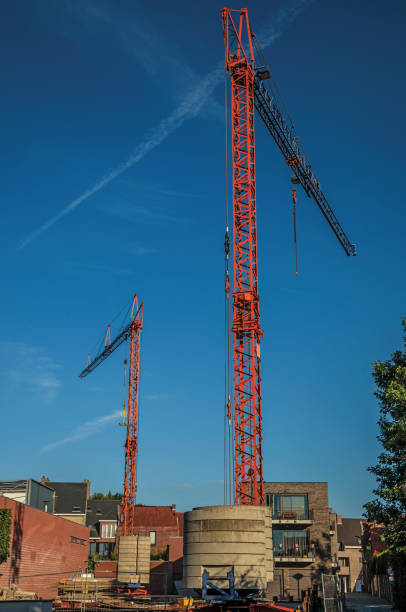 istock Construction area with cranes at sunset and blue bright sky in Tielt. 902452308