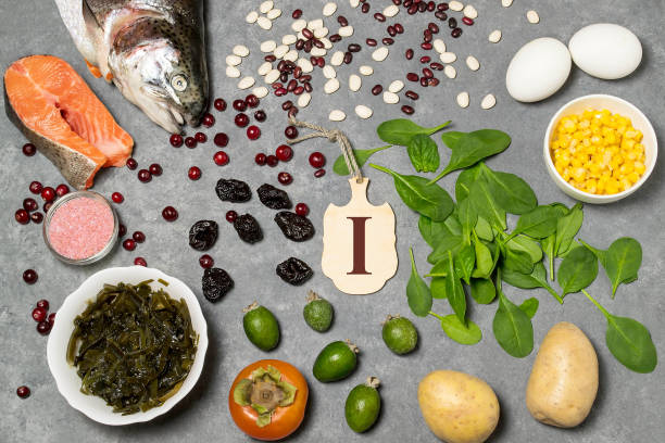 Food is source of iodine Food is source of iodine. Various food rich in vitamins and micronutrients. Useful food for health and balanced diet. Prevention of avitaminosis. Small cutting board with name of iodine. Top view vitamin rich stock pictures, royalty-free photos & images