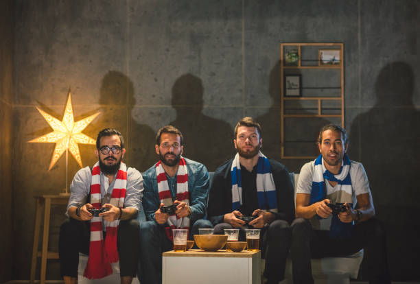 istock Men Socializing at Home - Playing Video Games 902459894