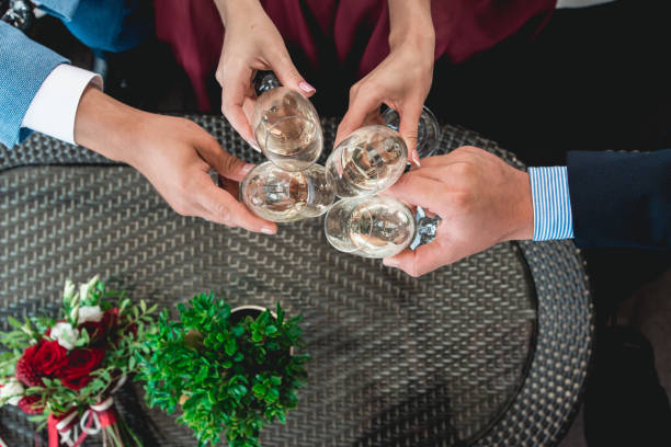 istock People hold in hands glasses with white wine. wedding party. 902461346