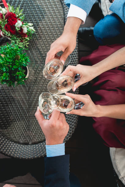 istock People hold in hands glasses with white wine. wedding party. 902462306