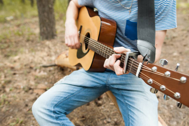 istock Music lifestyle man playing guitar nature concept. 902465586