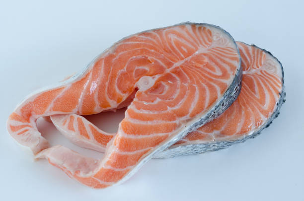 istock Raw sliced salmon on white background. Cenital plane. 902468610
