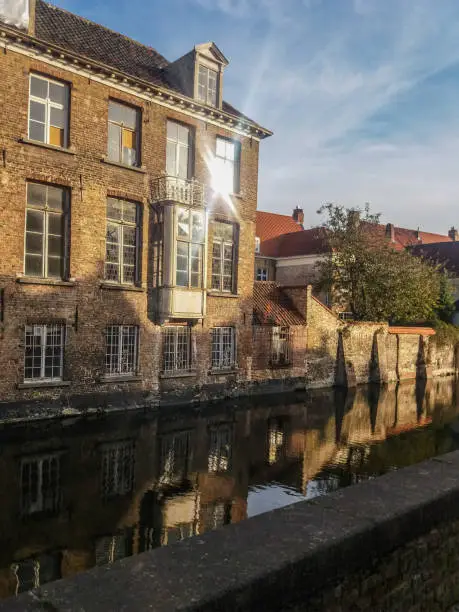 Photo of Canal and old buildings in the city of Bruges, Belgium.