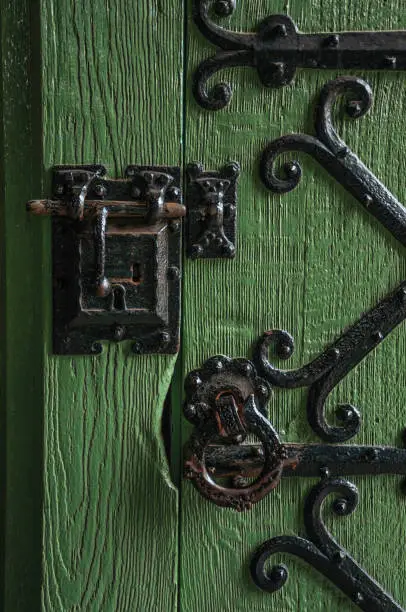 Detail of lock and hinge of iron on wooden door in Gravensteen Castle at Ghent. In addition to intense cultural life, the city is full of Gothic buildings and Flemish architecture. Northern Belgium.