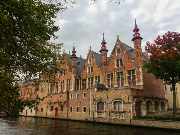 Photo of Canal and old buildings in the city of Bruges, Belgium.