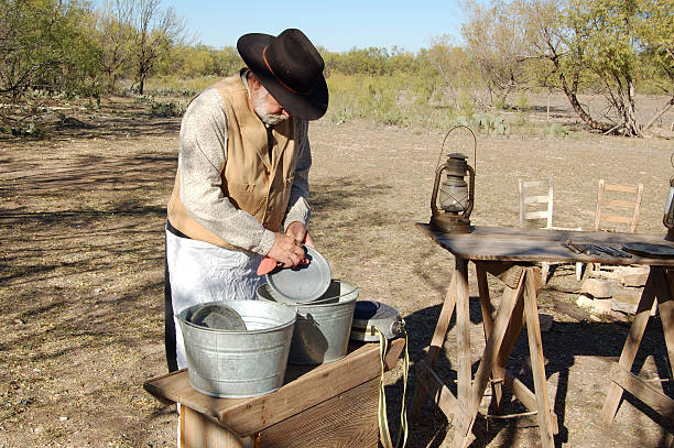 Washing Dishes  chuck wagon stock pictures, royalty-free photos & images