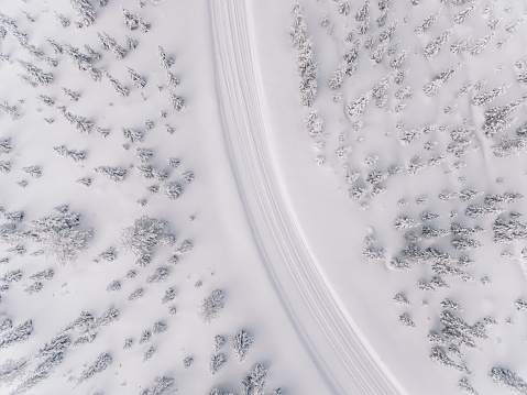 Aerial view of the road in the winter snow forest in Finland, Lapland