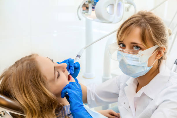 istock Woman Dentist working with a Female Patient 902492236