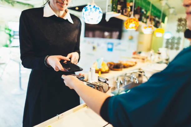 istock Woman Making Contactless Payment In Cafe 902492716