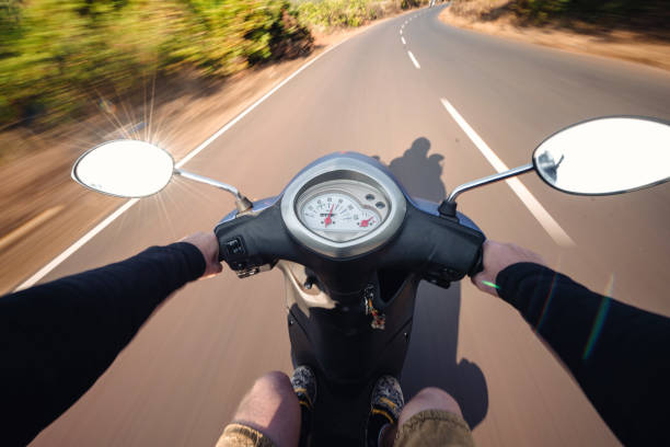 istock Rider driving scooter on an asphalt road. Motion blurred backgro 902496550