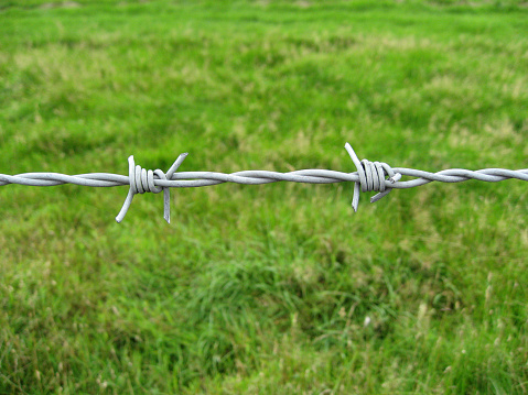 Roll of barbed wire on a wooden fence post in the Bergisches Land region of Germany