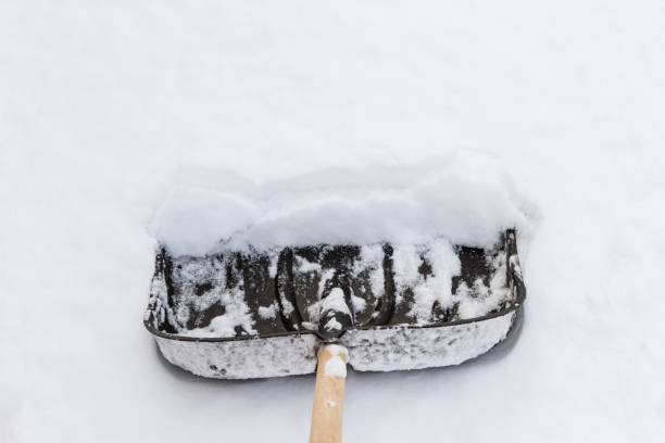 istock big black shovel in white snow cleaning 902497914