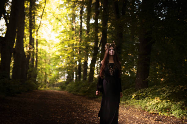 istock Beautiful woman  in dark forest. 902500868