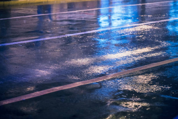 puddles after heavy rain on the road on summer day.