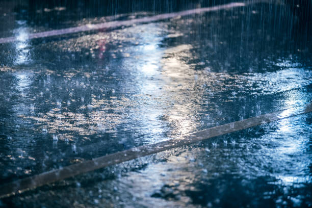 istock colored lights reflected in the wet asphalt in the rain 902500918