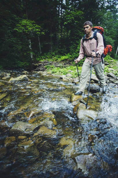istock Summer hike in the mountains with a backpack and tent. 902504462