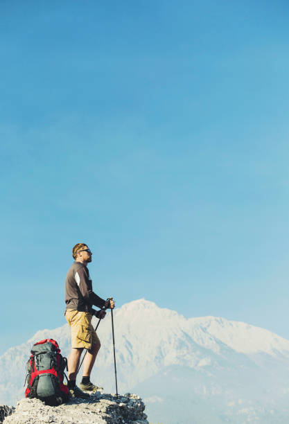 istock Summer hike in the mountains with a backpack and tent. 902504500
