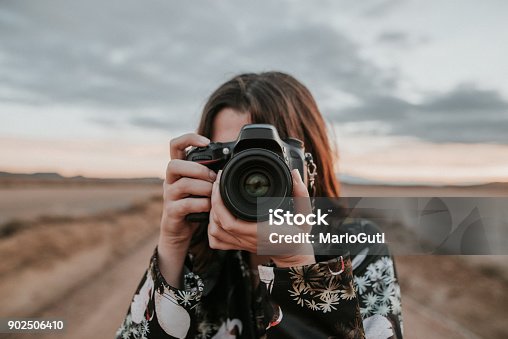 istock Young woman taking a picture 902506410