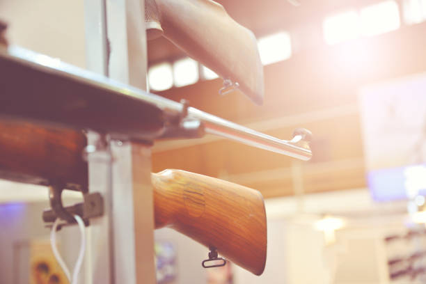 Sound suppressor or sound moderator and Iron sights on the gun barrel of semi-automatic rifled carbine, standing on stand. Iron sight in shallow DoF(depth of field).