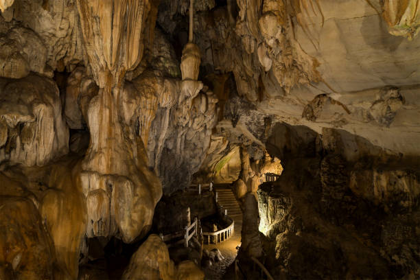 istock Cave with concrete foot path and light in Laos, Asia 902517930