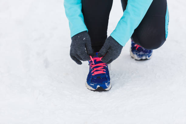 istock Tying sport shoes in snow 902520280