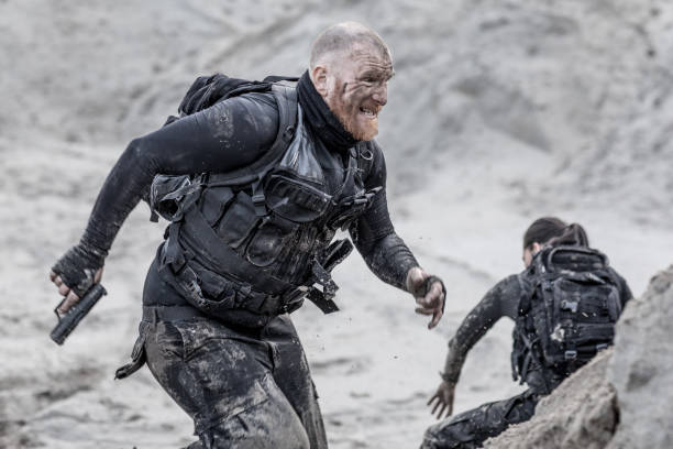 istock Redhead shaved male military member training hard on a sand hill run 902520758