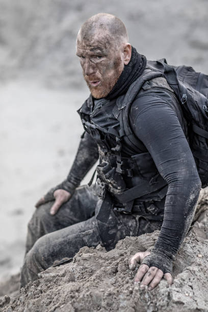 istock Redhead shaved male military member training hard on a sand hill run 902521374