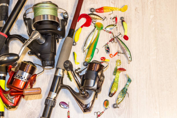 Fishing rod with a reel and lure, background Fishing rod with a reel and lure, background hunting decoy photos stock pictures, royalty-free photos & images