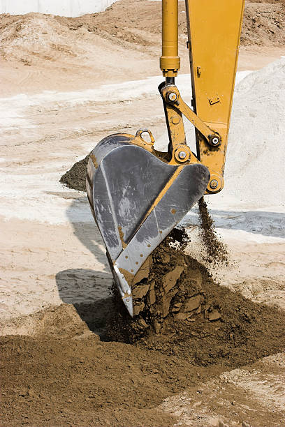 istock Excavator dumping its load of dirt. 90252309