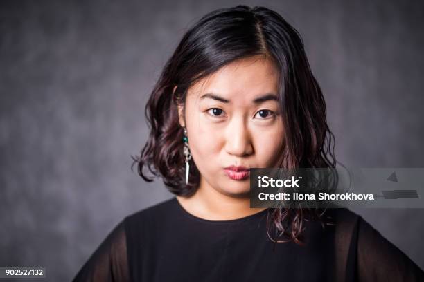 Funny Asian Woman Ina Black Dress On Gray Background Stock Photo - Download  Image Now - iStock