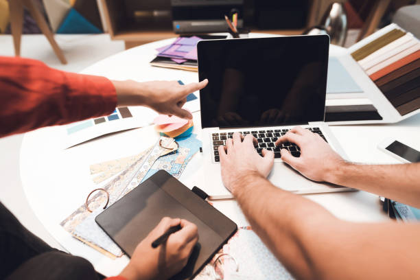 istock On the desk is a laptop, on which the man prints the text. 902528200