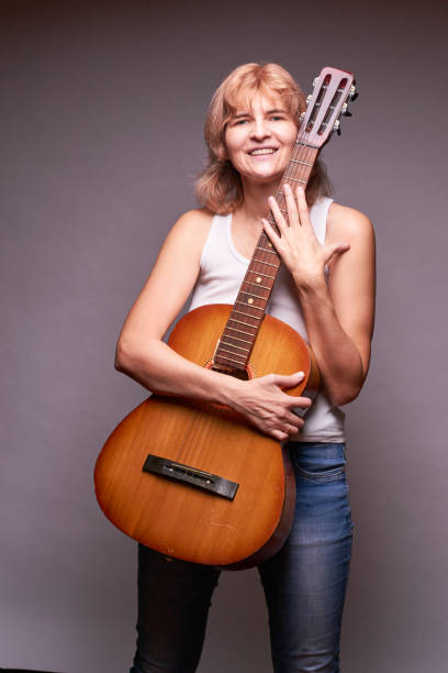 istock woman holding guitar 902531356