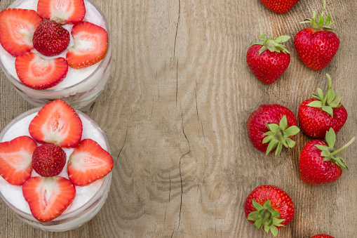 Dessert with cream and fresh strawberries (can be used as background, card)