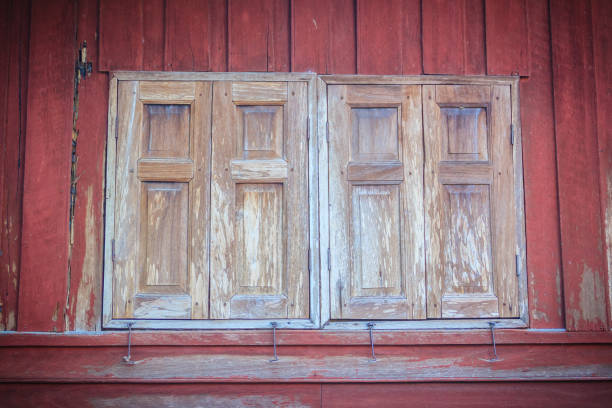 istock Old vintage wooden brown house windows background. 902538620